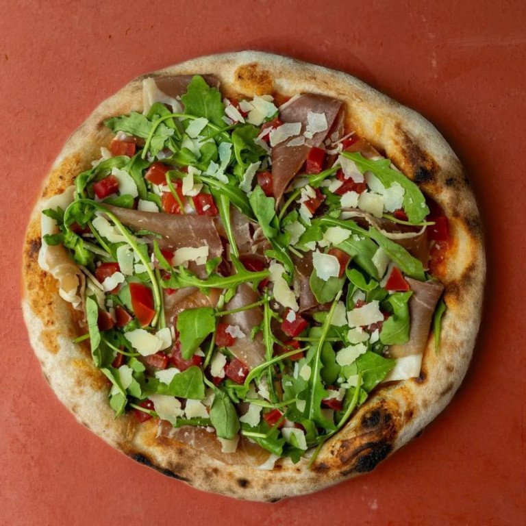 pizza with prosciutto and arugula at bono pizzeria
