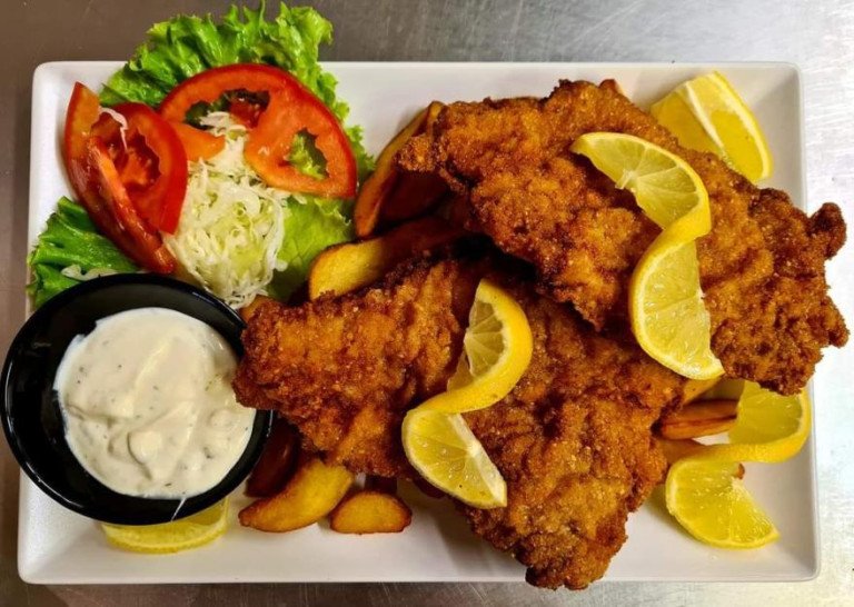 Crispy Wiener Schnitzel served with roasted potatoes, lemon, and tartar sauce
